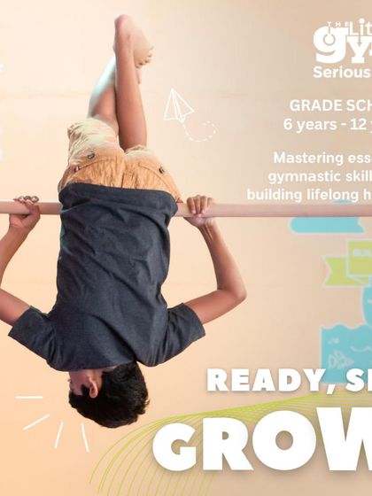 Our grade school program is about mastering essential gymnastic skills and building lifelong habits. This student is practicing an inverted hang, a move that requires significant core and upper body strength.