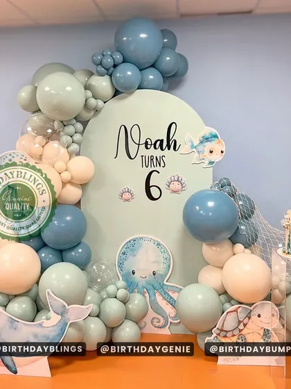 A beautiful "Under the Sea" theme with a muted, earthy color palette. The sage green, teal, and cream balloons create a calm and serene ocean vibe.