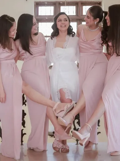 A fun and stylish pose with the bride and her bridesmaids, showing off their shoes. We love creative and playful group shots.