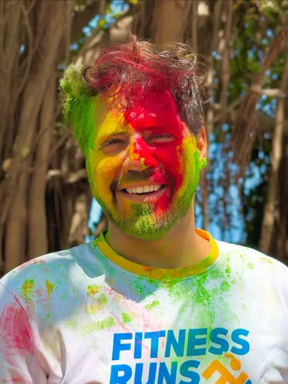 A happy, color-smeared face. This picture perfectly captures the spirit of joyful, uninhibited celebration.
