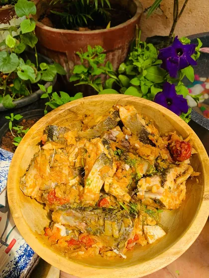 A bowl of fresh river water fish curry, with my garden in the background.