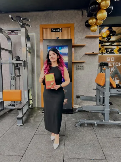 Holding my award at the gym. This recognition fuels my mission to spread positivity and make fitness accessible and enjoyable for everyone, which is the core of my nutrition coaching service.