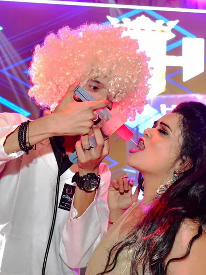 Dr. Gulati in action on the main stage, giving a guest a syringe shot. This shows how my entertainment can be integrated into the main event, not just at the bar.
