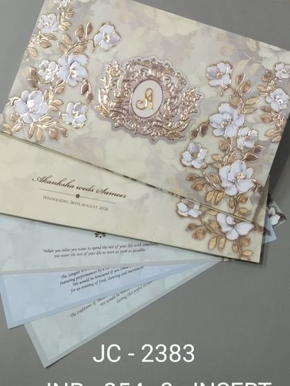 This premium invitation features a beautiful spray of 3D flowers with a custom monogram. The textured background and gold foil accents add to its luxurious feel.