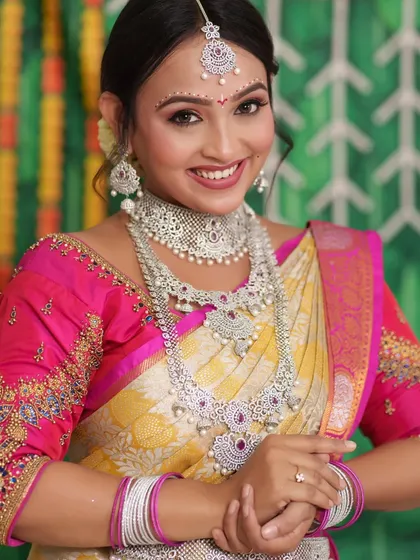 A happy bride at her reception, wearing a full American Diamond set. The jewellery adds a touch of glamour to her yellow and pink saree.