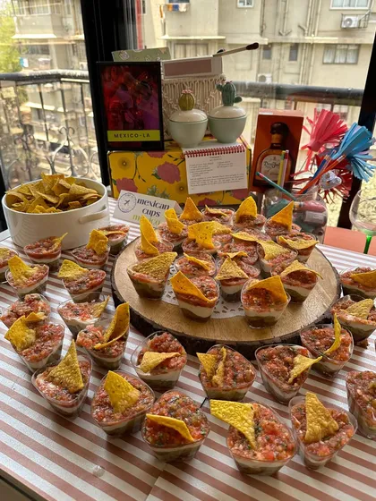 My bite-sized savory cups are perfect for mingling. These individual Mexican cups are layered with beans, salsa, and sour cream, and topped with a nacho chip. They are easy to grab and delicious to eat.