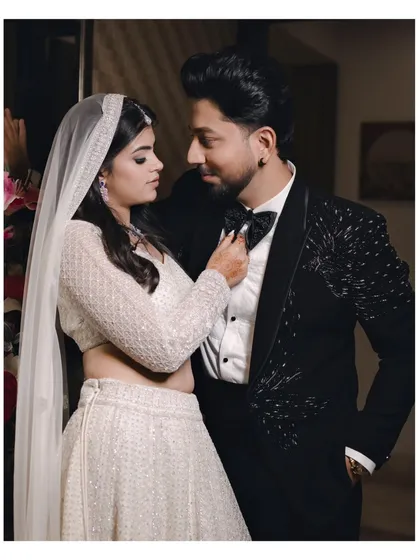 A playful and romantic moment between the couple. The bride adjusts the groom's bow tie, their close proximity and smiles creating an intimate portrait.