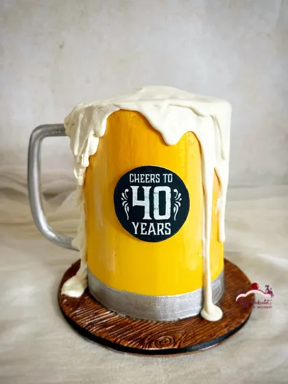 Cheers to 40 years! A fun beer mug cake, complete with overflowing foam made from buttercream.