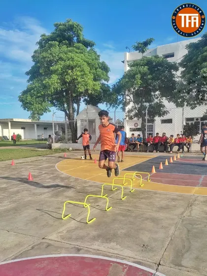 Agility ladder and hurdle drills on the basketball court, showcasing our use of different facilities to improve footwork and coordination.