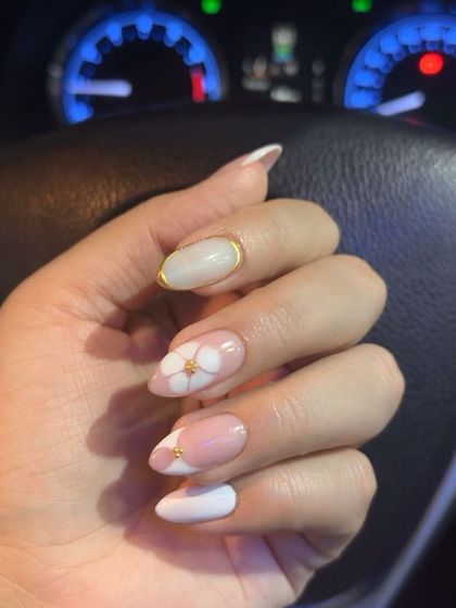 The blossom gel nails seen in different lighting, showing off the gold chrome.