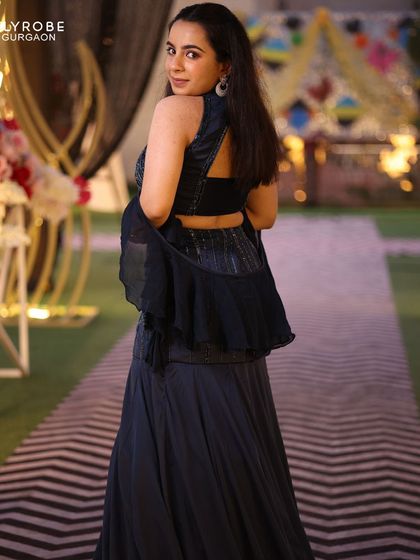 A back view of the stylish navy blue outfit, showing off its modern design and flattering silhouette. She looks amazing.