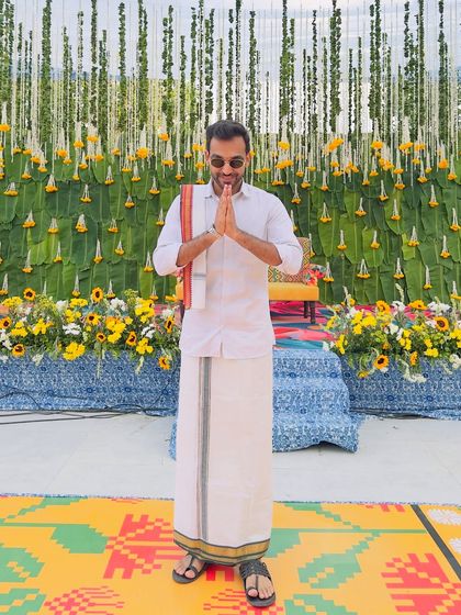 Greeting guests with a traditional 'namaskaram' at a South Indian themed wedding. It's these small cultural details that make a themed event feel truly authentic.