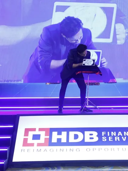 Here at the HDB Financial Services IPO success party, I'm performing my iPad magic. This form of digital illusion is perfect for both stage and close-up settings, allowing me to bring the magic directly to your guests.