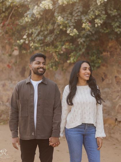 A candid walking shot, capturing them hand-in-hand. These unposed moments often result in the most natural and joyful photographs, showing the couple simply enjoying their time together.
