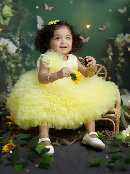 A happy smile from our yellow fairy, enjoying her time in the whimsical garden setup we created.
