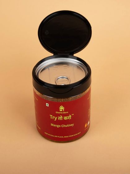 A jar of Mango Chutney with its lid open, showing the pull-tab seal to indicate freshness and secure packaging.