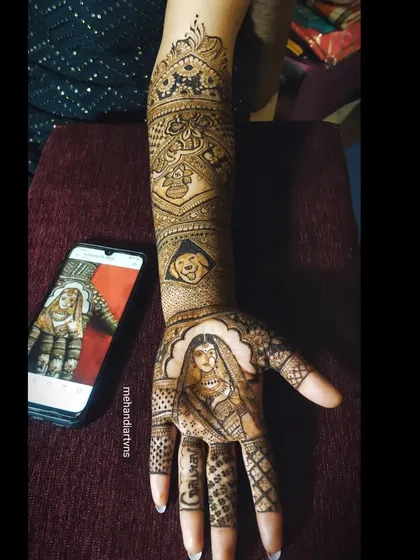 Capturing the bride's portrait from a reference photo. I take great care to replicate the details of the bride's attire and expression in my henna art.
