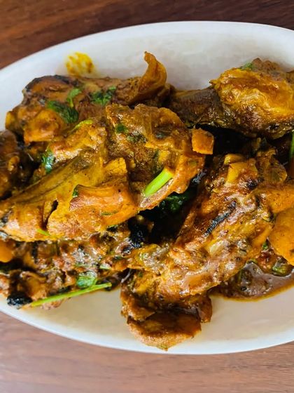 A clean, simple shot of the chicken curry on a white plate.