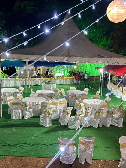 An evening event setup with guest seating and our buffet line visible in the background. We manage the entire catering and seating arrangement to ensure your event runs smoothly from start to finish.