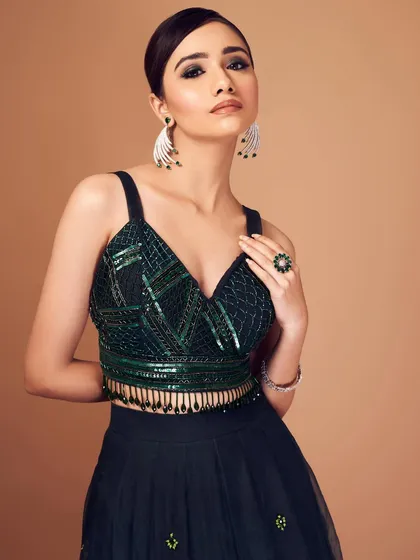 Dropping a bomb in emerald hues. This look is all about drama, with a dark, smoky eye that complements the sequined green top perfectly.