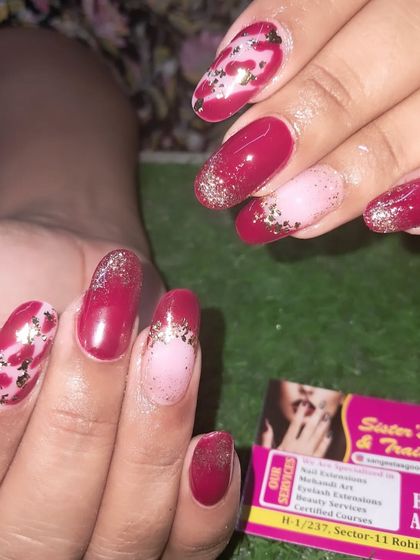 A beautiful red nail set with glitter and foil accents for a festive look.