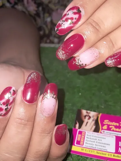 A beautiful red nail set with glitter and foil accents for a festive look.