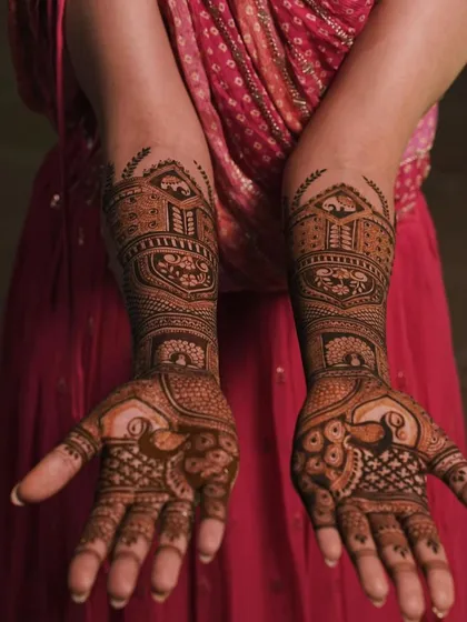 A full view of a traditional design with peacocks on the palms and architectural elements on the forearms. This is a classic and elegant choice for any bride.
