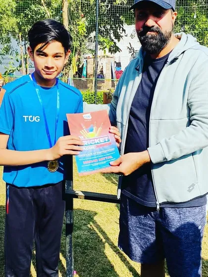 A young player receives his certificate and medal at the Junior BCL prize distribution ceremony.