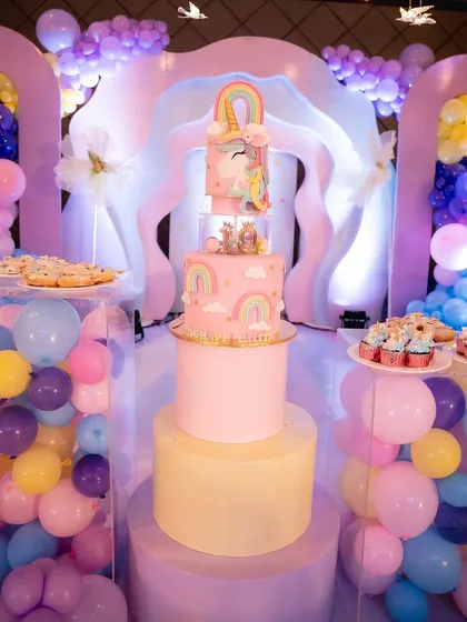 Even the cake has to match the theme! This incredible three-tier unicorn cake was the centerpiece of the dessert table, surrounded by pastel balloons and treats.