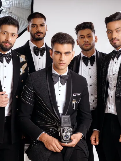 A group of groomsmen showcasing our range of designer tuxedos. Each suit features unique details, from varied lapel styles to distinct embellishments, creating a coordinated but not uniform look for a modern wedding party.