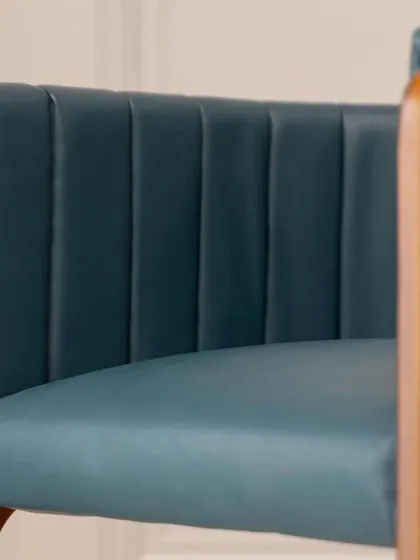 The graceful curve of the backrest on our new accent chair. The design is both modern and timeless, crafted to be a beautiful and comfortable addition to any living space.
