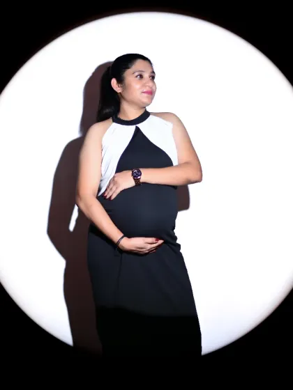 This is one of my signature studio styles, using a single spotlight to create an elegant and timeless solo portrait. The focused light beautifully sculpts your baby bump, turning your pregnancy silhouette into a true work of art.