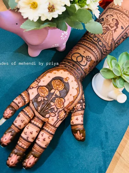 A beautifully styled shot of my bridal mehendi work. The design includes a couple portrait on the arm and a floral motif on the palm, perfect for capturing memories.