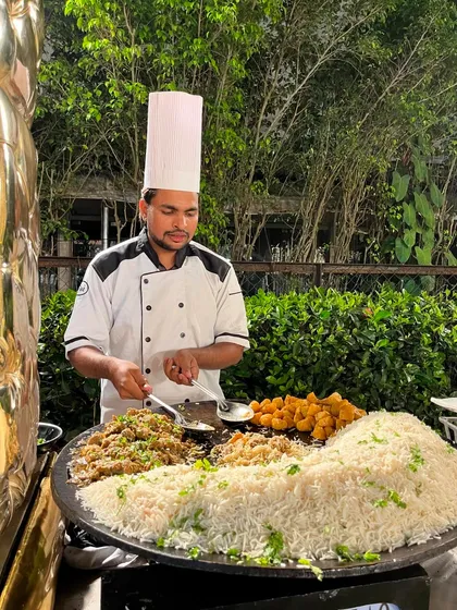 The Mutton Tawa Pulao station, where my chef serves up this delicious one-pan meal, showcasing the interactive nature of my catering service.