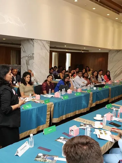This is me in my element, presenting to a room of energetic entrepreneurs. My workshops are interactive and practical, focusing on real-world strategies for building a powerful professional presence.