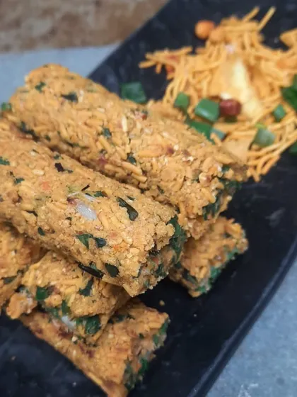 A truly unique creation, our Subzi Lasooni Chiwda Seekh combines minced vegetables with the crunch of garlic-flavored chiwda. It's a fusion starter that offers a surprising texture and savory taste.