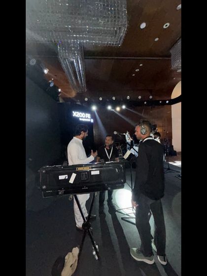 Our team coordinating with the camera crew at the Vivo launch event. We ensure all technical teams are in sync.