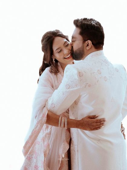 A bright, high-key photo of the groom giving his fiancée a happy kiss on the cheek. These light-filled, joyful images are a staple of my engagement photography.