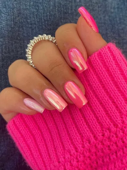 A stunning pink chrome manicure. This polish has an iridescent finish that catches the light beautifully, making it more than just a simple pink.