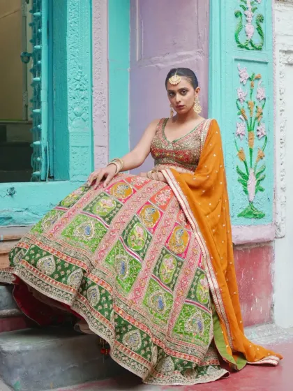 This lehenga is a piece of art. The skirt features colorful panels with intricate peacock and floral embroidery, making it a unique masterpiece for a bride who wants something truly special. It’s a celebration of heritage and craftsmanship.
