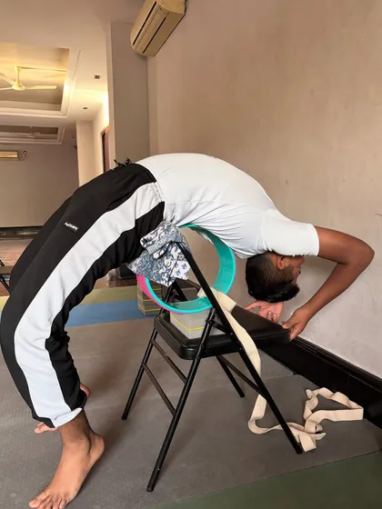 Another example of using a chair and wheel for a supported, deep backbend, allowing the practitioner to relax into the pose.