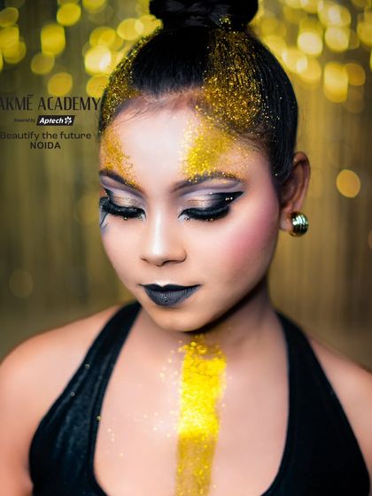 A creative glam look featuring bold black lipstick and gold glitter. Our courses encourage students to experiment with unconventional styles to build a unique and artistic portfolio.