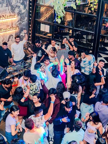 An overhead shot of the packed dance floor at Bombay Adda. "Bangalore is an Emotion" on the wall says it all.