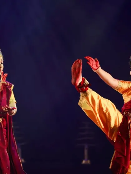The dynamic energy of a Bharatanatyam duet in full flow. This image captures the precision, coordination, and joyful spirit my senior dancers bring to the stage, ideal for events that require a focused and high-energy performance.