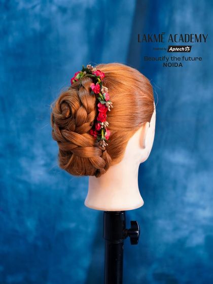 A classic rose bun hairstyle created on a mannequin. We teach you how to sculpt hair into beautiful shapes, like this floral design.