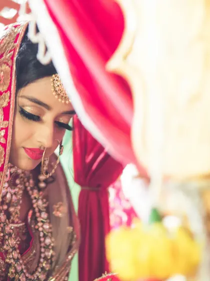 A quiet, contemplative moment of the bride during her wedding ceremony, captured with an artistic and shallow depth of field.