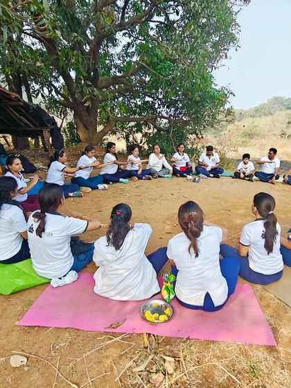 Our students gathered in a circle during a winter yoga trek. Taking our practice outdoors connects us with nature and deepens our sense of community.