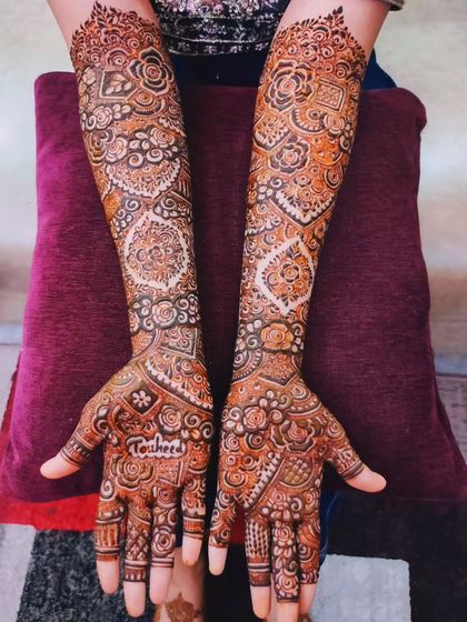 A stunning bridal design with a rich, dark stain, personalized with the name 'Touheeda'.