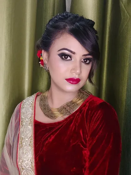 A classic party look with a red velvet blouse. The makeup is timeless with winged eyeliner and a bold red lip.