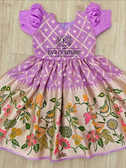 A one-piece frock with a unique Paithani and Kalamkari print combination. The bodice has a diamond pattern, and the skirt features colorful birds and flowers.